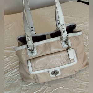 Coach purse beige and white with several pockets inside and out.